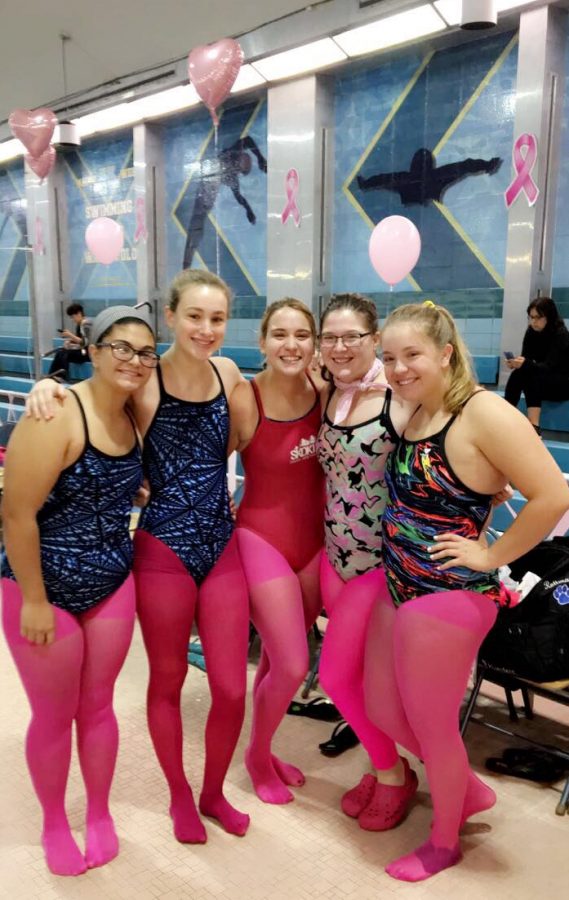 Swim team shows their support for breast cancer awareness month.