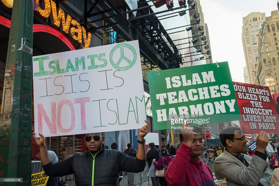 TIMES SQUARE, NEW YORK, NY, UNITED STATES - 2015/11/21: Demonstrators at the rally in Times Square hold aloft printed and handmade signs condemning ISIS and the attacks carried out by the Islamic State in the name of Islam. About a hundred members of New Yorks Muslim-American community and non-Muslim supporters gathered in Times Square for the two-fold purpose of expressing grief for the victims of recent attacks by Islamic State extremists and to condemn the Islamic States radical interpretation of Islam and the terrorist acts carried out by them. (Photo by Albin-Lohr Jones/Pacific Press/LightRocket via Getty Images)