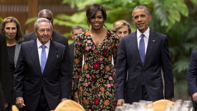 President Obama wif his wife and President Castro in Cuba. Photo Credit: Chris Carlson/AP.
